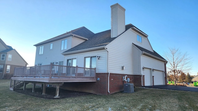 back of property with cooling unit, a lawn, and a wooden deck