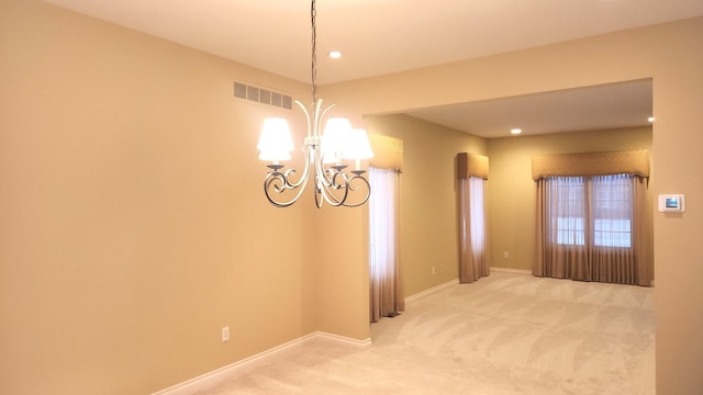 unfurnished dining area featuring a chandelier and carpet floors