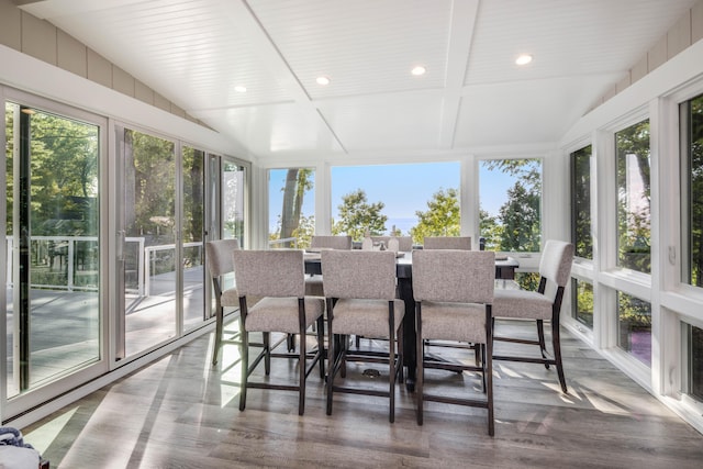 sunroom / solarium featuring vaulted ceiling with beams and wood ceiling