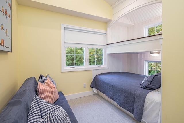 bedroom featuring light carpet and baseboards