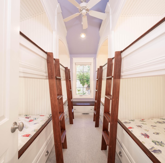 carpeted bedroom with vaulted ceiling and ceiling fan