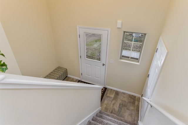 stairs featuring hardwood / wood-style floors