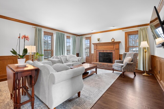 living room with ornamental molding, a wealth of natural light, and wainscoting