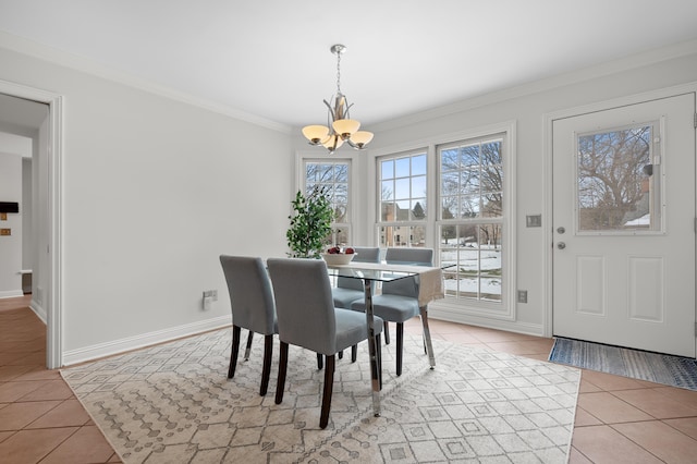 dining room featuring light tile patterned floors, ornamental molding, a chandelier, and baseboards