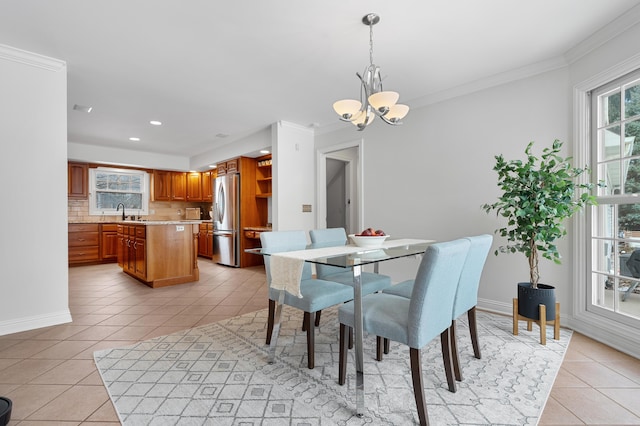 dining room featuring light tile patterned floors, recessed lighting, crown molding, baseboards, and an inviting chandelier