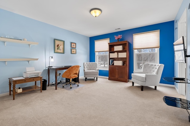 office featuring baseboards, visible vents, and light colored carpet