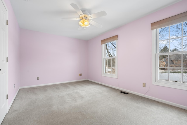 unfurnished bedroom with visible vents, baseboards, a ceiling fan, and light colored carpet
