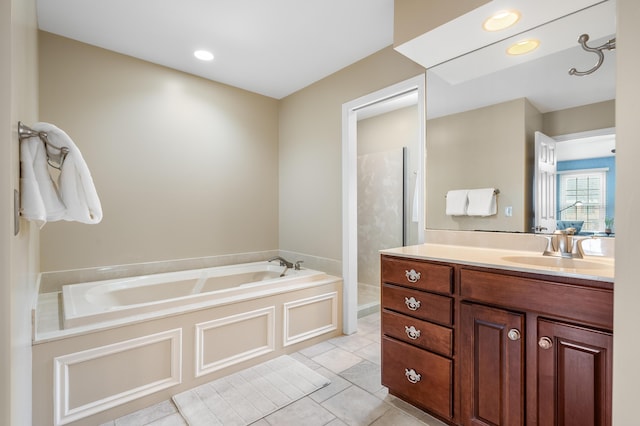 full bath with recessed lighting, a garden tub, vanity, and tile patterned floors
