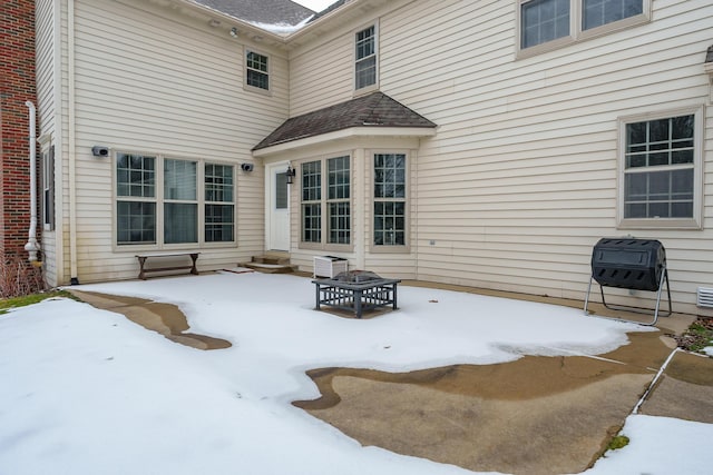 exterior space with entry steps and roof with shingles