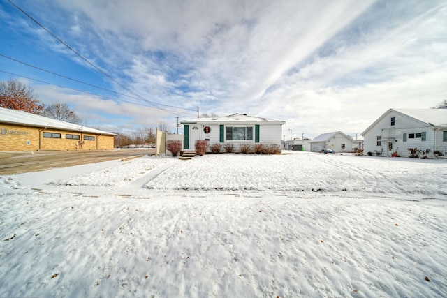 view of snow covered back of property