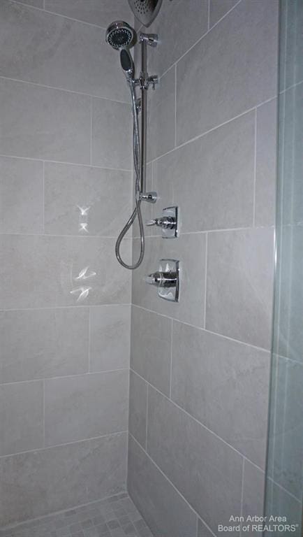 bathroom with tiled shower