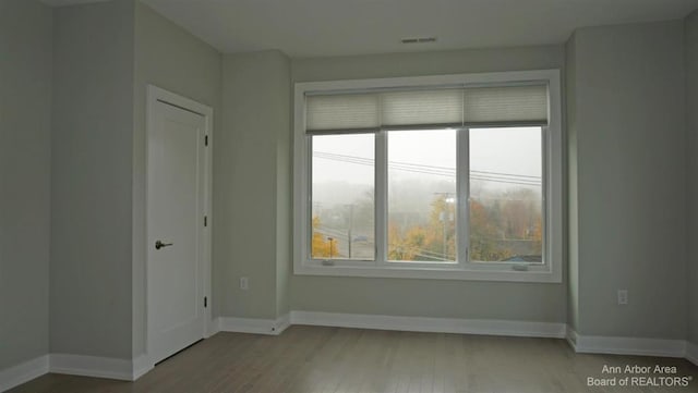 unfurnished room featuring light hardwood / wood-style floors