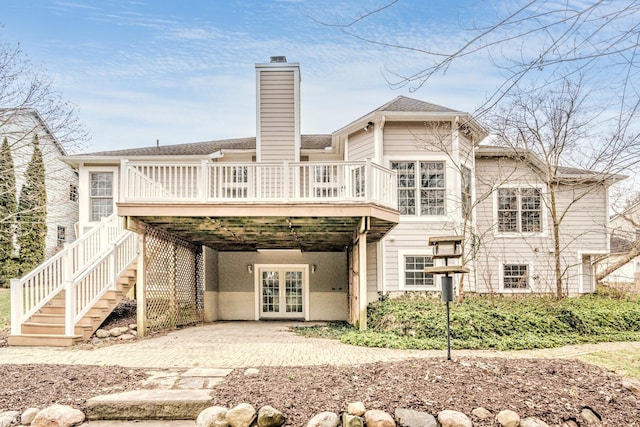 back of house featuring french doors and a deck