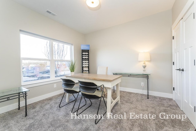 office area featuring light carpet and vaulted ceiling