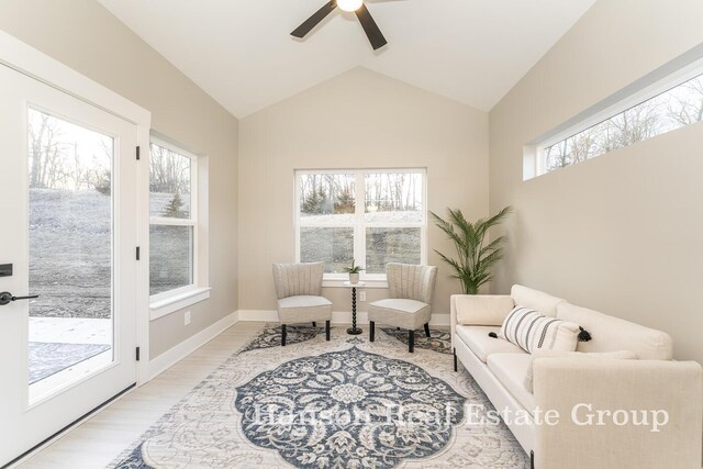 living area with plenty of natural light, ceiling fan, and lofted ceiling