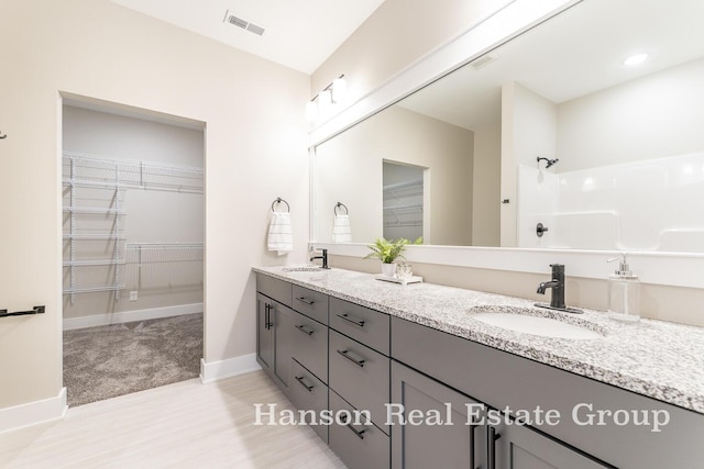 bathroom featuring vanity and walk in shower