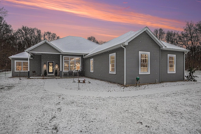 view of back house at dusk