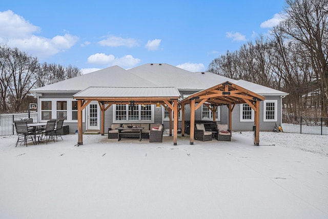 snow covered rear of property featuring outdoor lounge area