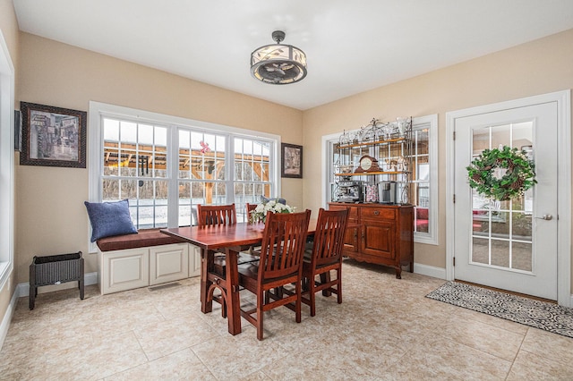 dining space featuring light tile patterned floors