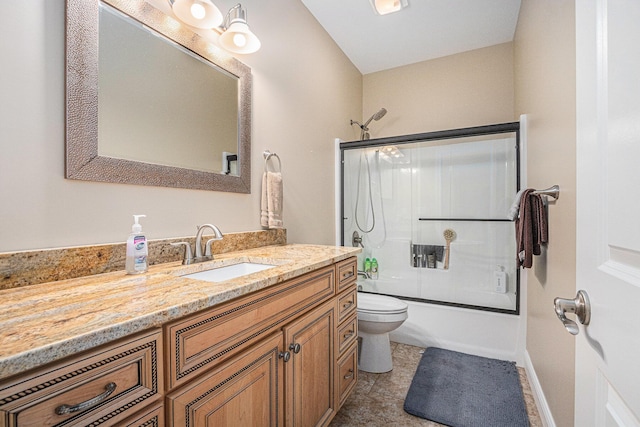 full bathroom featuring vanity, enclosed tub / shower combo, and toilet