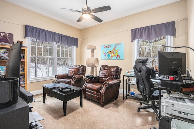 office space with light colored carpet and ceiling fan