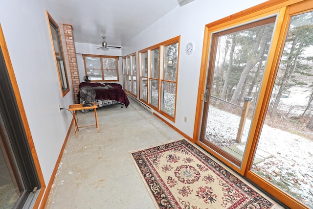 sunroom / solarium featuring ceiling fan and plenty of natural light