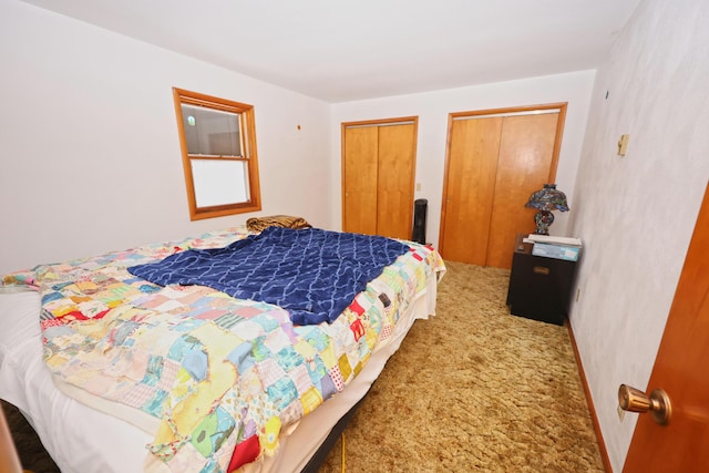 carpeted bedroom featuring multiple closets