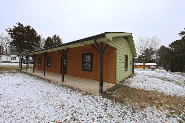 view of snowy exterior featuring a patio area