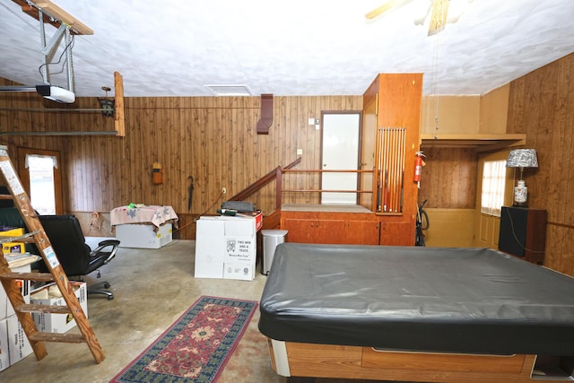 recreation room with billiards and wooden walls