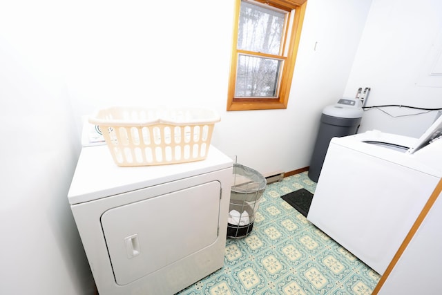 laundry room with a baseboard heating unit and washing machine and clothes dryer