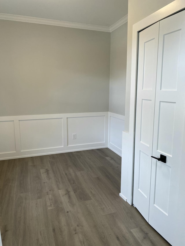 spare room with dark hardwood / wood-style flooring and ornamental molding