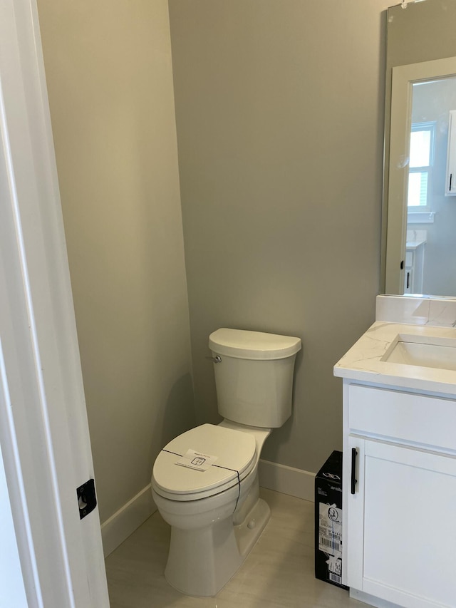 bathroom featuring tile patterned floors, vanity, and toilet