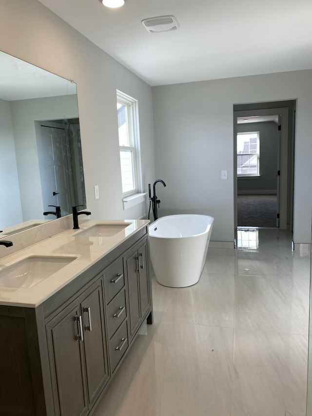 bathroom with a bathing tub and vanity