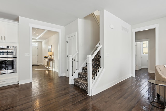 stairway with hardwood / wood-style flooring