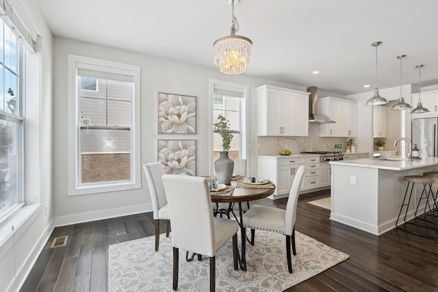 dining area featuring plenty of natural light, dark hardwood / wood-style floors, and sink