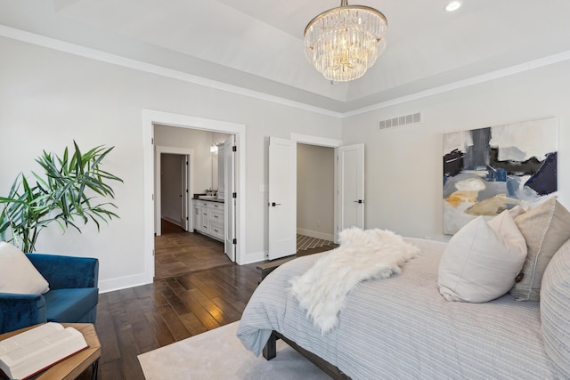 bedroom with a notable chandelier, ensuite bath, dark hardwood / wood-style floors, and a towering ceiling