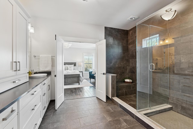 bathroom featuring tile patterned floors, vanity, and an enclosed shower