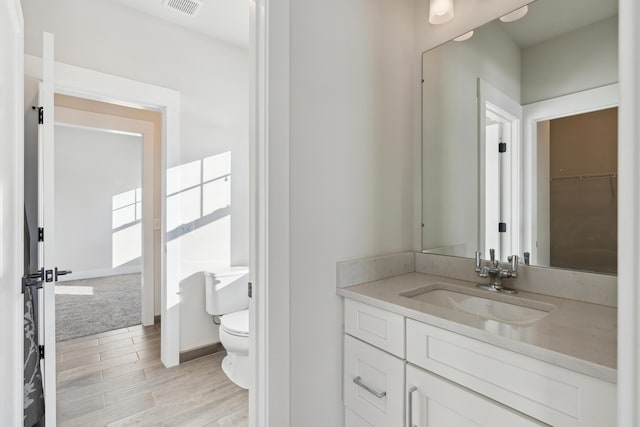 bathroom with vanity and toilet