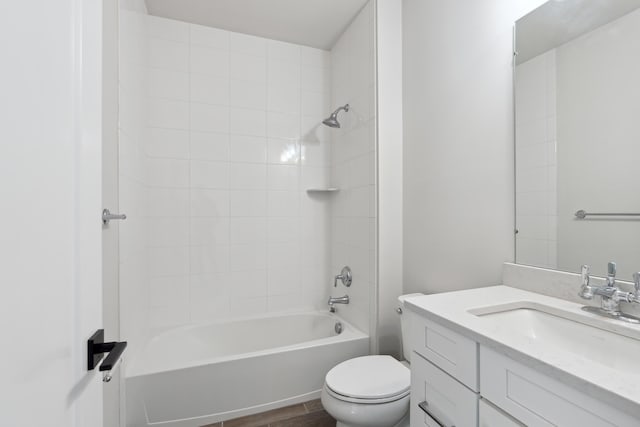 full bathroom featuring vanity, tiled shower / bath combo, wood-type flooring, and toilet