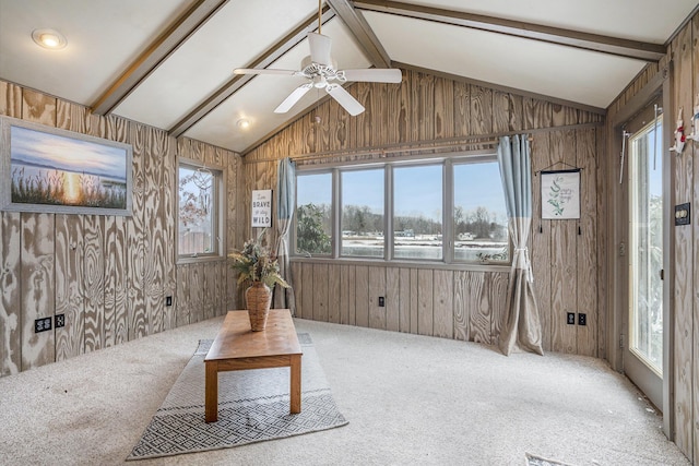 unfurnished sunroom with vaulted ceiling with beams, ceiling fan, and a healthy amount of sunlight