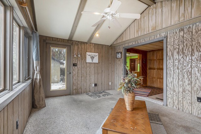 sunroom featuring lofted ceiling with beams and ceiling fan