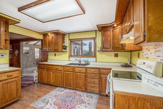 kitchen featuring white range with electric stovetop, sink, and light hardwood / wood-style flooring