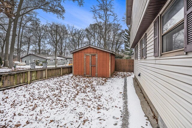 snowy yard with a storage unit