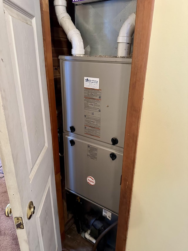 utility room featuring heating unit