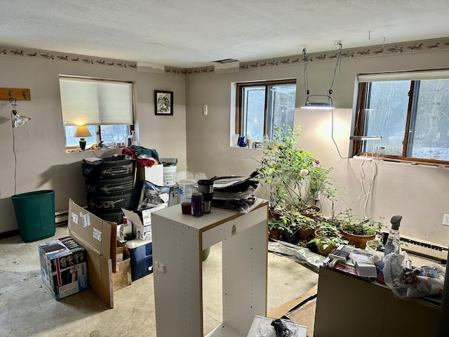 miscellaneous room featuring a textured ceiling and plenty of natural light