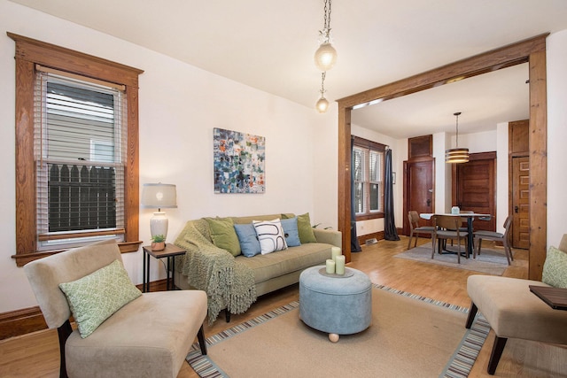 living room featuring a healthy amount of sunlight and light hardwood / wood-style floors