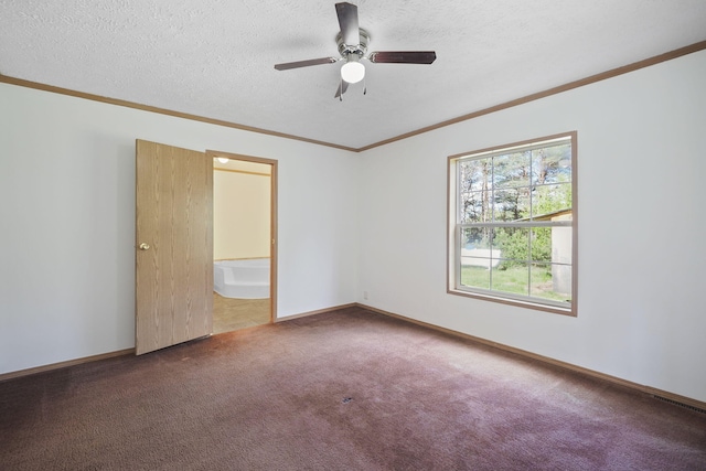 carpeted empty room with ceiling fan, crown molding, and a textured ceiling