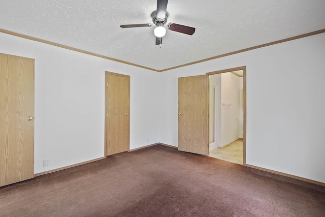 carpeted spare room with a textured ceiling, ceiling fan, and crown molding