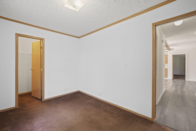 carpeted spare room featuring crown molding and a textured ceiling