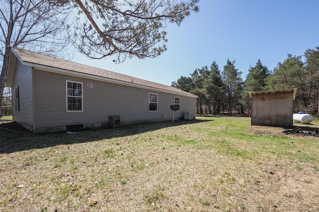 rear view of house with a yard and cooling unit